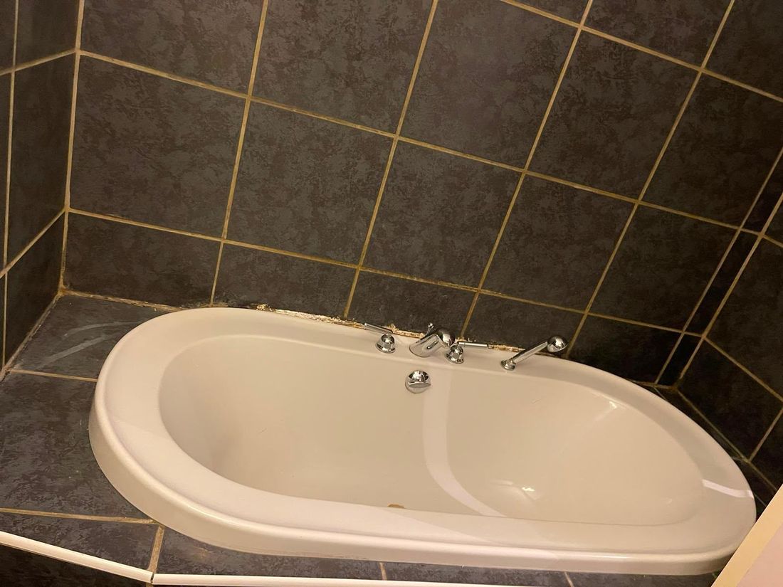 Clean white bath with polished chrome taps
