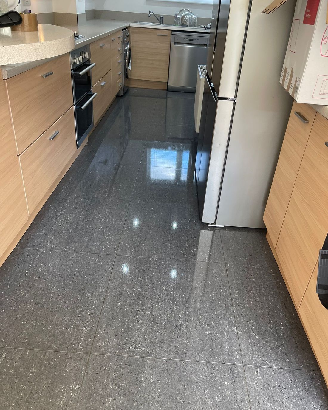 Kitchen with polished dark floor tiles