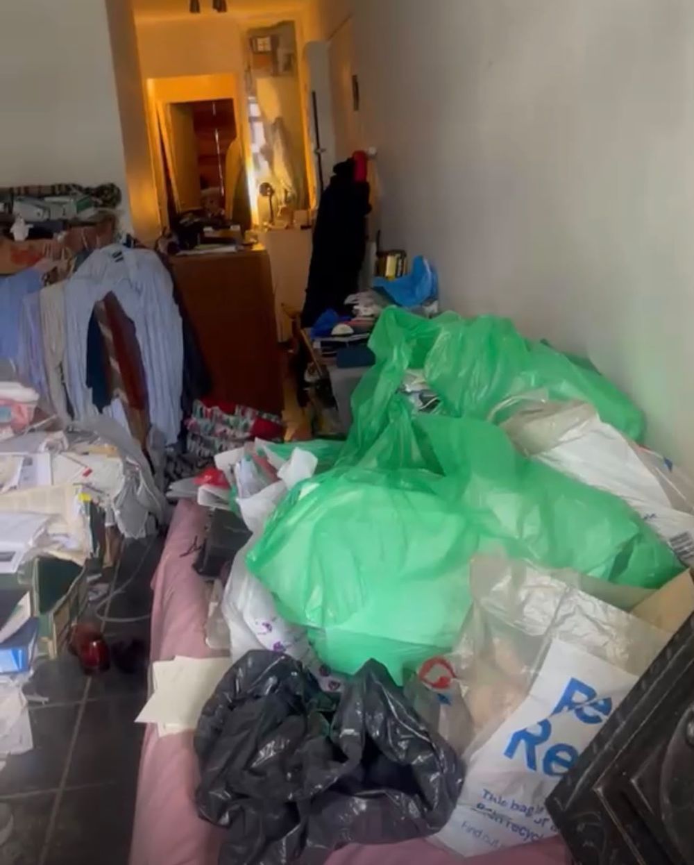 A room filled with bags, clothes and paperwork before a G&L deep clean